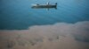 Serbia - An angler sits in a boat on the Sava river in Belgrade on October 23, 2019, near a sewage output. 