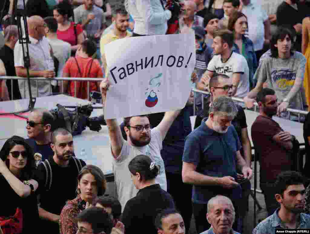 A sign with the portmanteau Gavnilov that combines the last name of Russian State Duma Deputy Sergei Gavrilov -- who sat in the Georgian parliamentary speaker's chair during a meeting of international lawmakers on June 20, angering the protesters -- and the word "govno," which means crap. Demonstrators view Gavrilov as an ally of Putin and say he backs Russia's support for the breakaway regions of South Ossetia and Abkhazia. 