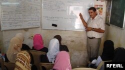 Iraqi girls attend an English class. The high rate of school drop-outs has worsened Iraq's illiteracy problem.